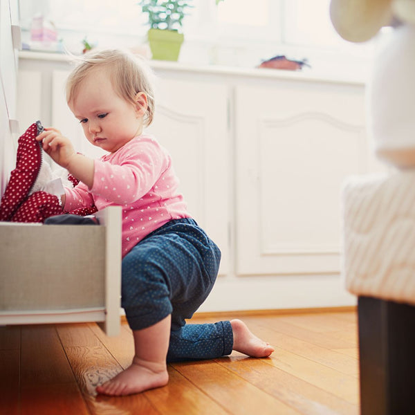 toddler getting into a drawer exploring around the house